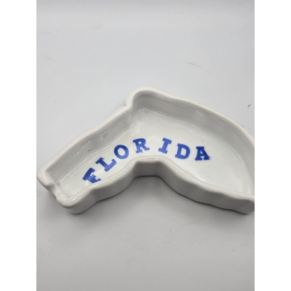 a vintage porcelain souvenir dish in the shape of the state of Florida.